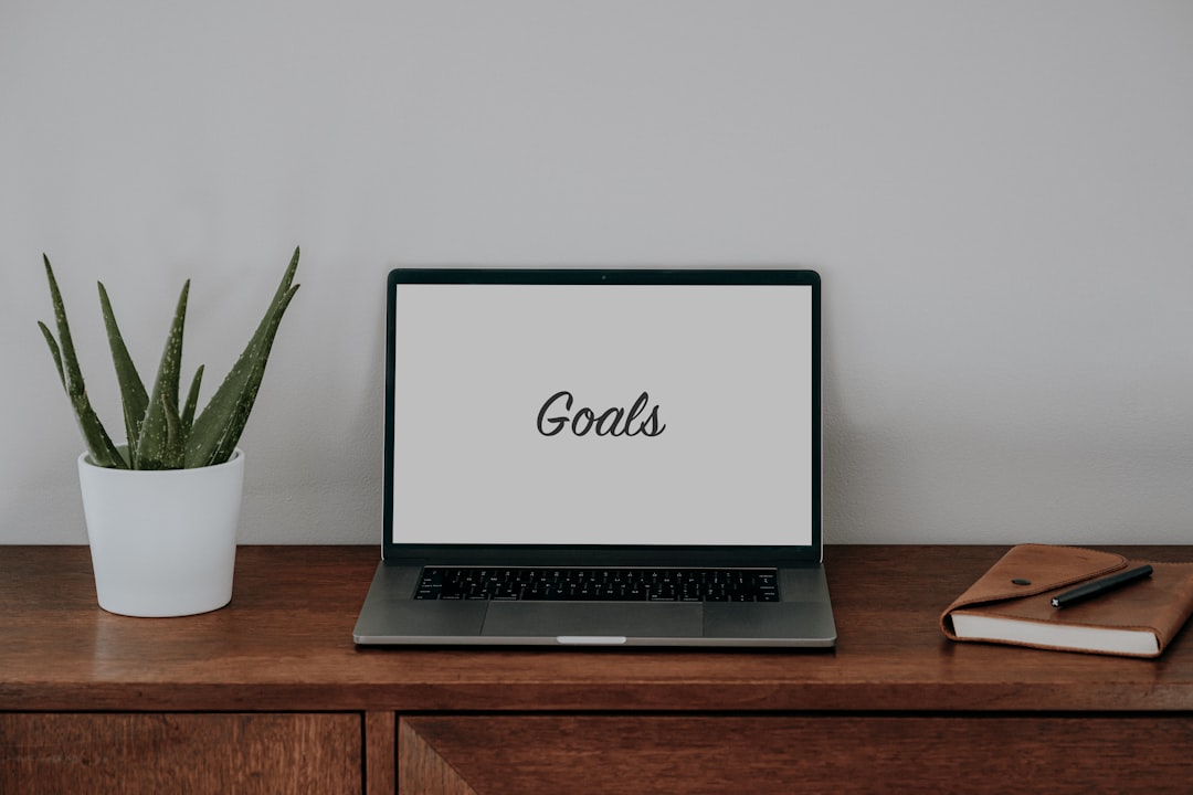 a laptop on a desk with the word goals on it.